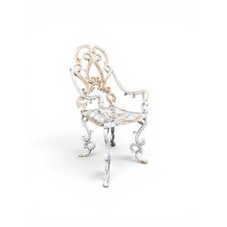 Pair of Victorian cast iron garden chairs, the ornate pierced back of scrolling foliate design, scrolling arm terminals over splayed supports formed of C and S-scrolls, in distressed white painted finish