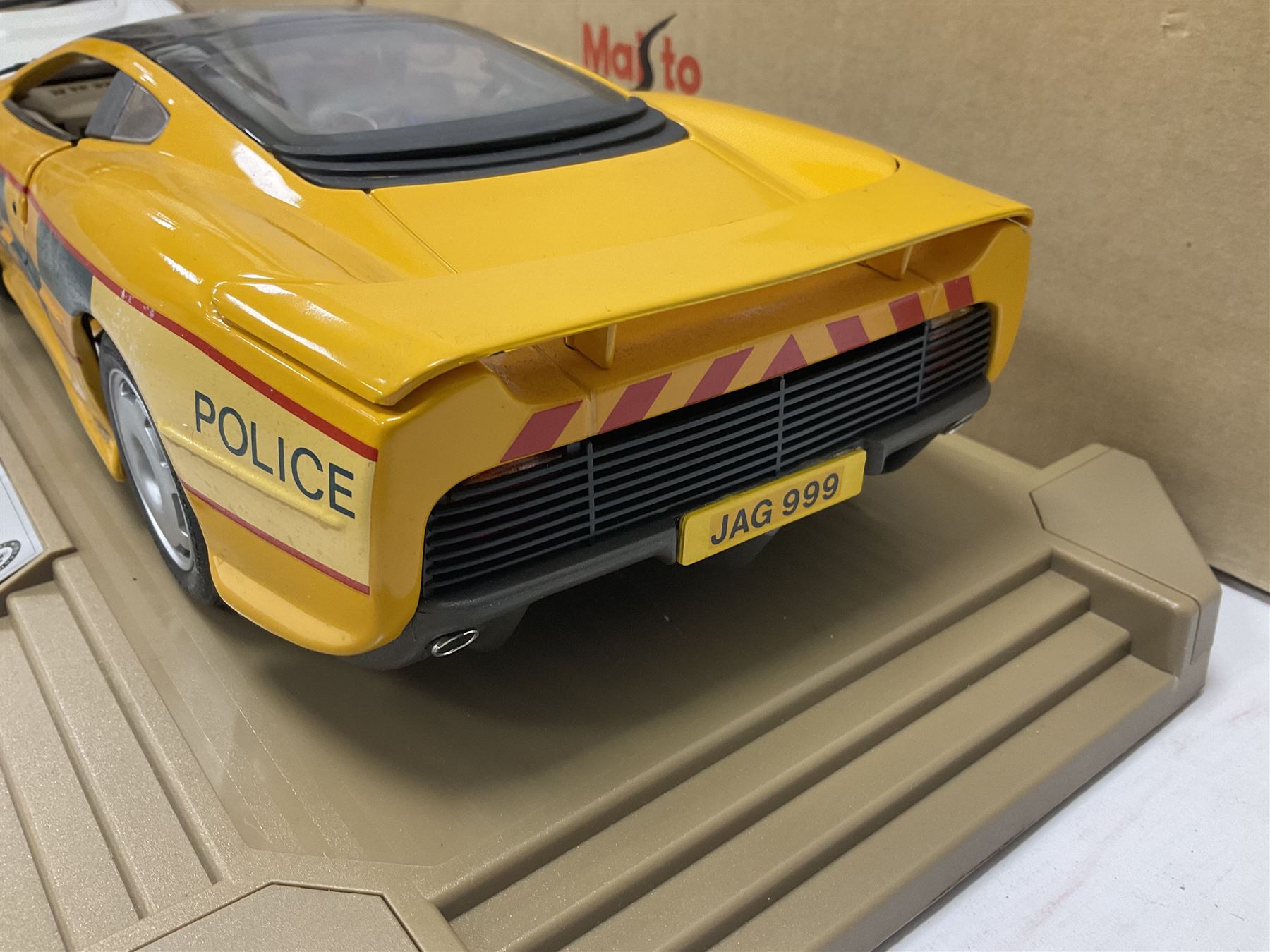 Two Maisto 1:12 scale Jaguar XJ220 scale cars comprising 1992 ‘Concept Car’ West Midlands Police car and 1994 ‘Jag 999’ Thames Valley Police Traffic Car, both on plinths with original boxes and certificates of authenticity 