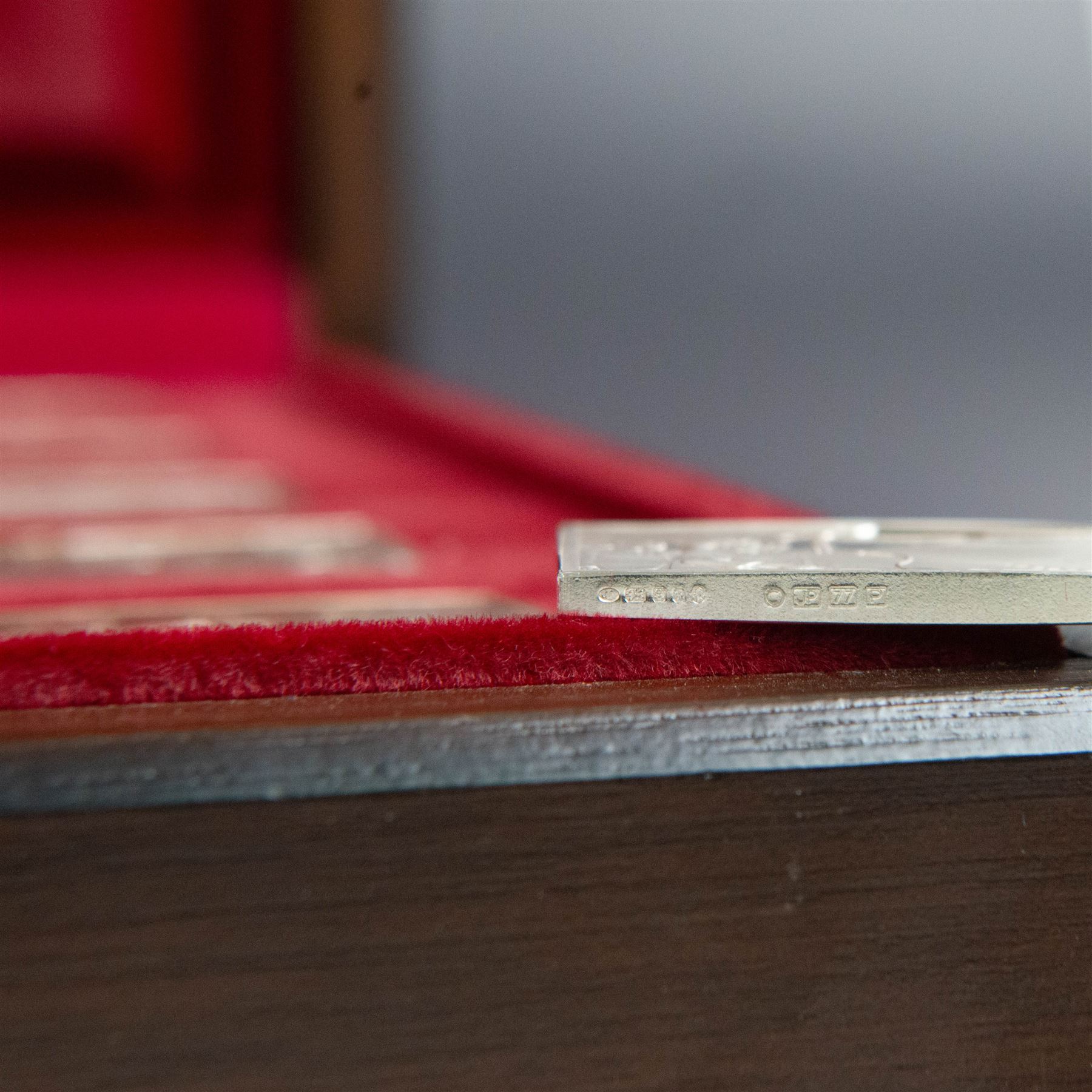 Elizabeth Our Queen silver ingots collection, twenty-five rectangular ingots each decorated in relief with a Royal scene, hallmarked John Pinches Ltd, London 1976, in wooden presentation case with information booklet