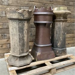 Collection of three Victorian and early 20th century reclaimed terracotta chimney pots, comprising: one cylindrical form with weathered, cracked glaze and flared octagonal base; one deep red cylindrical pot with fluted midsection and castellated rim, bearing moulded number ‘25’; and one tapering hexagonal example with wide flared rim and weathered patina. All with age-related wear and chips, consistent with use and outdoor exposure. Plus a selection of cast stone pieces including fountain 