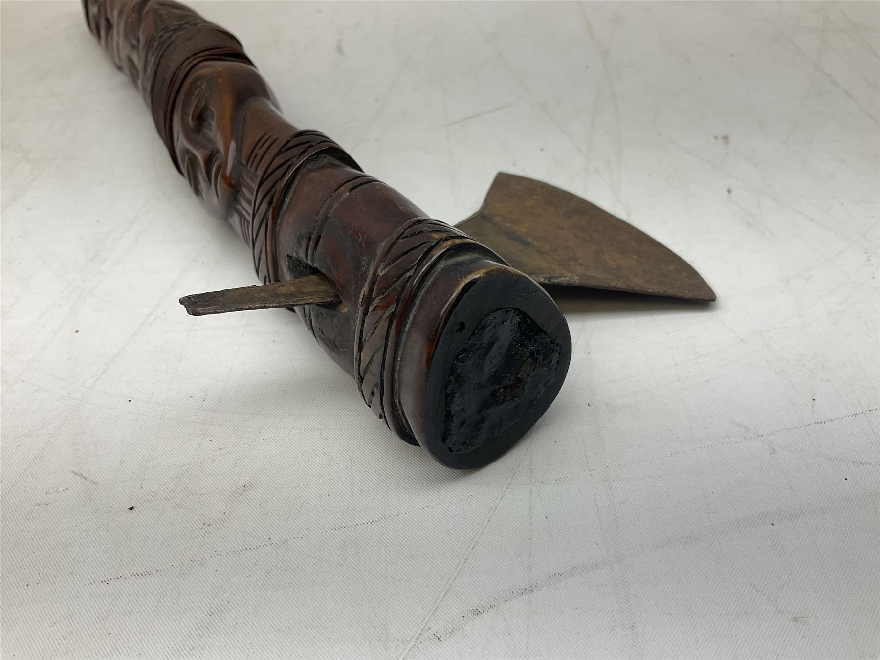 Tribal Art - an African axe, possibly Yoruba, the bone shaft carved as two cord bound stylised figures with iron fan-shaped blade, L35cm overall; and 19th century harpoon or spear head of square section with two long fixing arms on cut-down ash shaft L57cm (2)