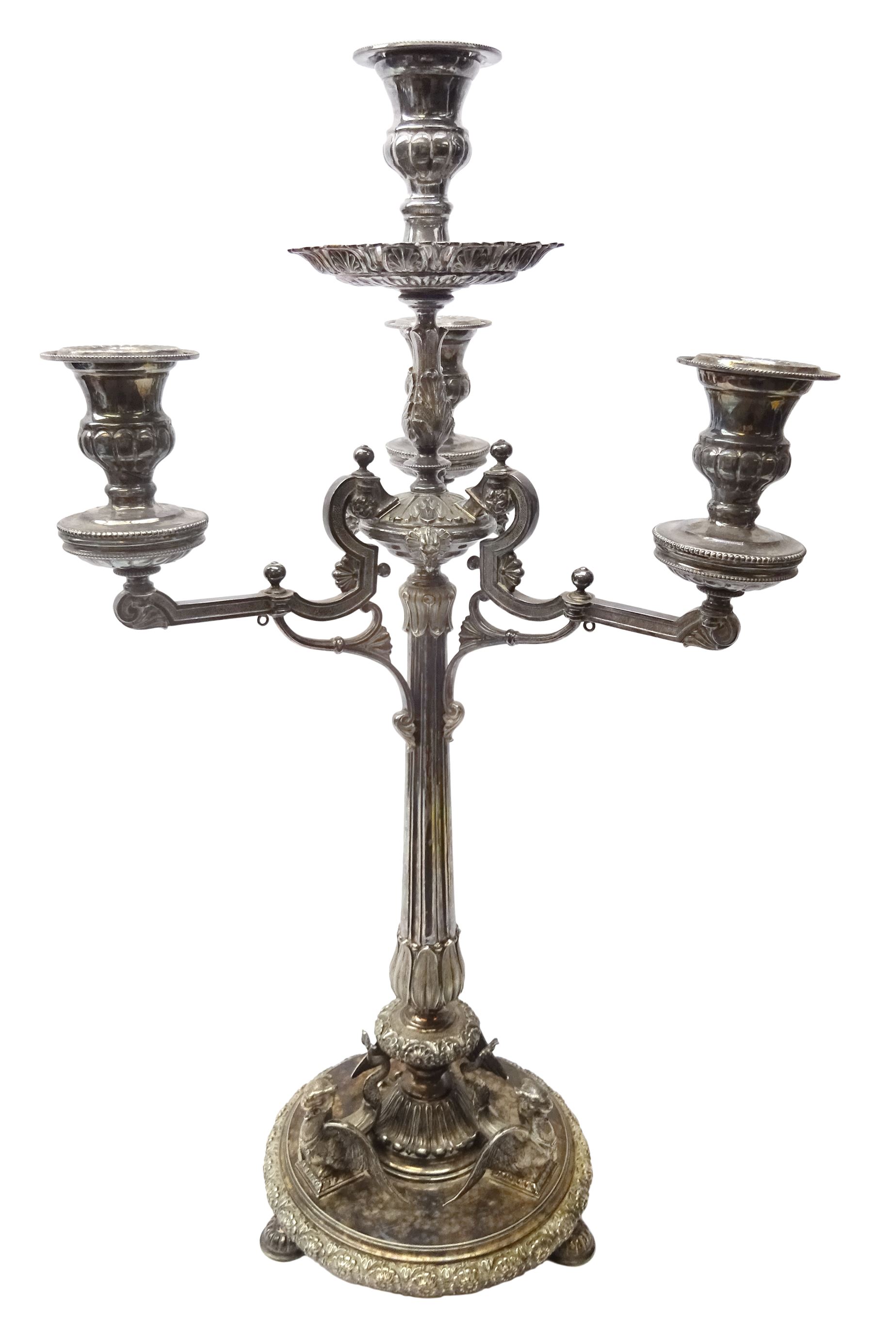 A large Victorian Thomas Bradbury & Sons silver plated candelabrum, the circular base with flower head border upon three domed feet, supporting a central knopped and fluted column flanked by three zoomorphic creatures, leading to a central socket with removable nozzle above a large palmette detailed drip pan, and three scrolling branches with conforming sockets and nozzles, with maker's silver plate mark and Victorian registration lozenge beneath, H62.5cm