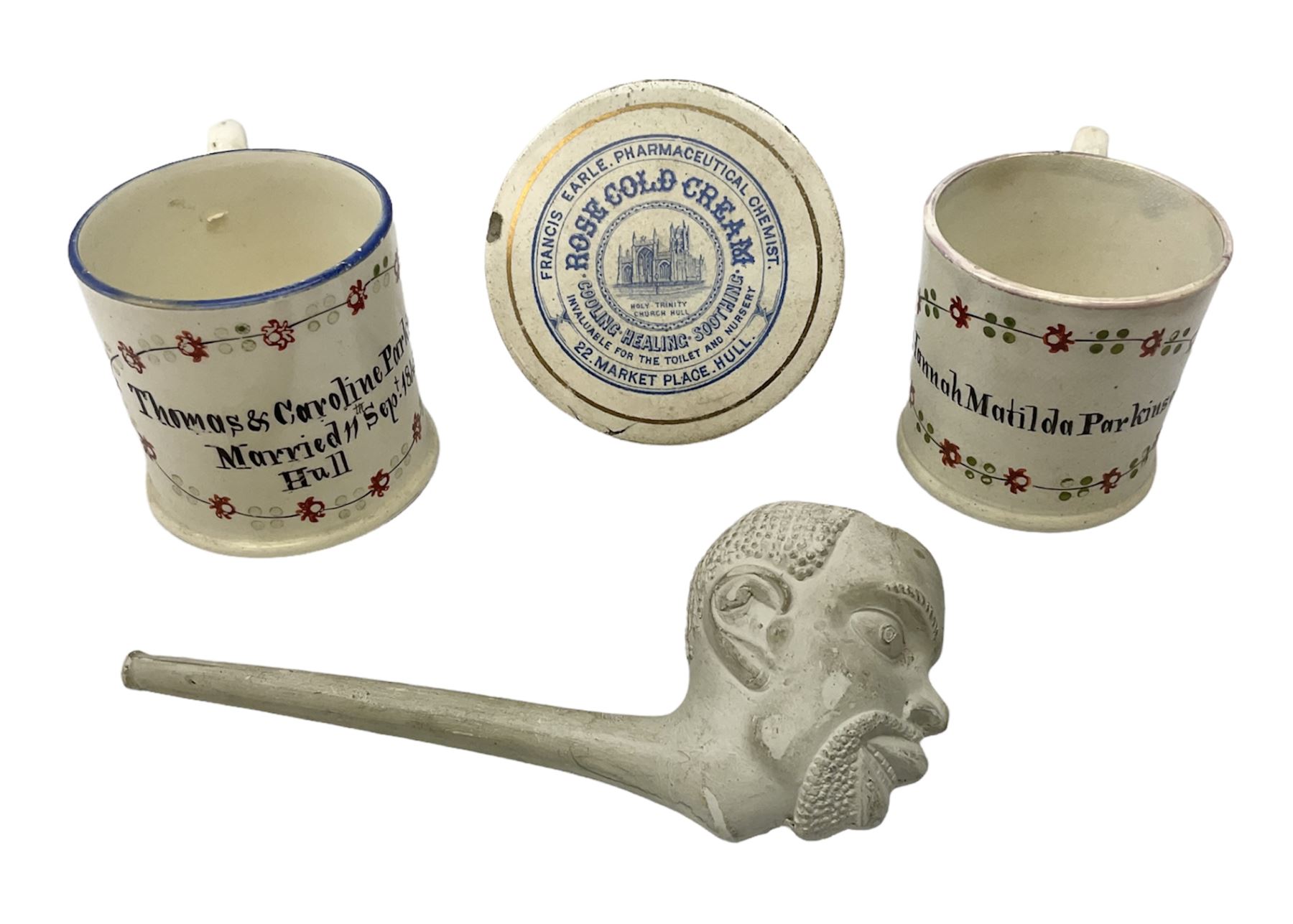  Early Victorian marriage mug for Thomas and Caroline Parkinson dated 11th Sept. 1845 Hull H8cm, similar christening mug for their daughter Hannah Matilda, blue/white transfer printed pot lid with base for Francis Earle, Pharmaceutical Chemist, 22 Market Place, Hull with central study of Holy Trinity Church and clay pipe, the bowl as man's head (4)  