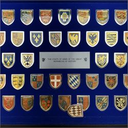 Franklin Mint 'The Coats of Arms of The Great Monarchs of History', a collection of fifty silver plated shields each decorated in enamel, contained in fitted case with glazed cover and box of information cards 