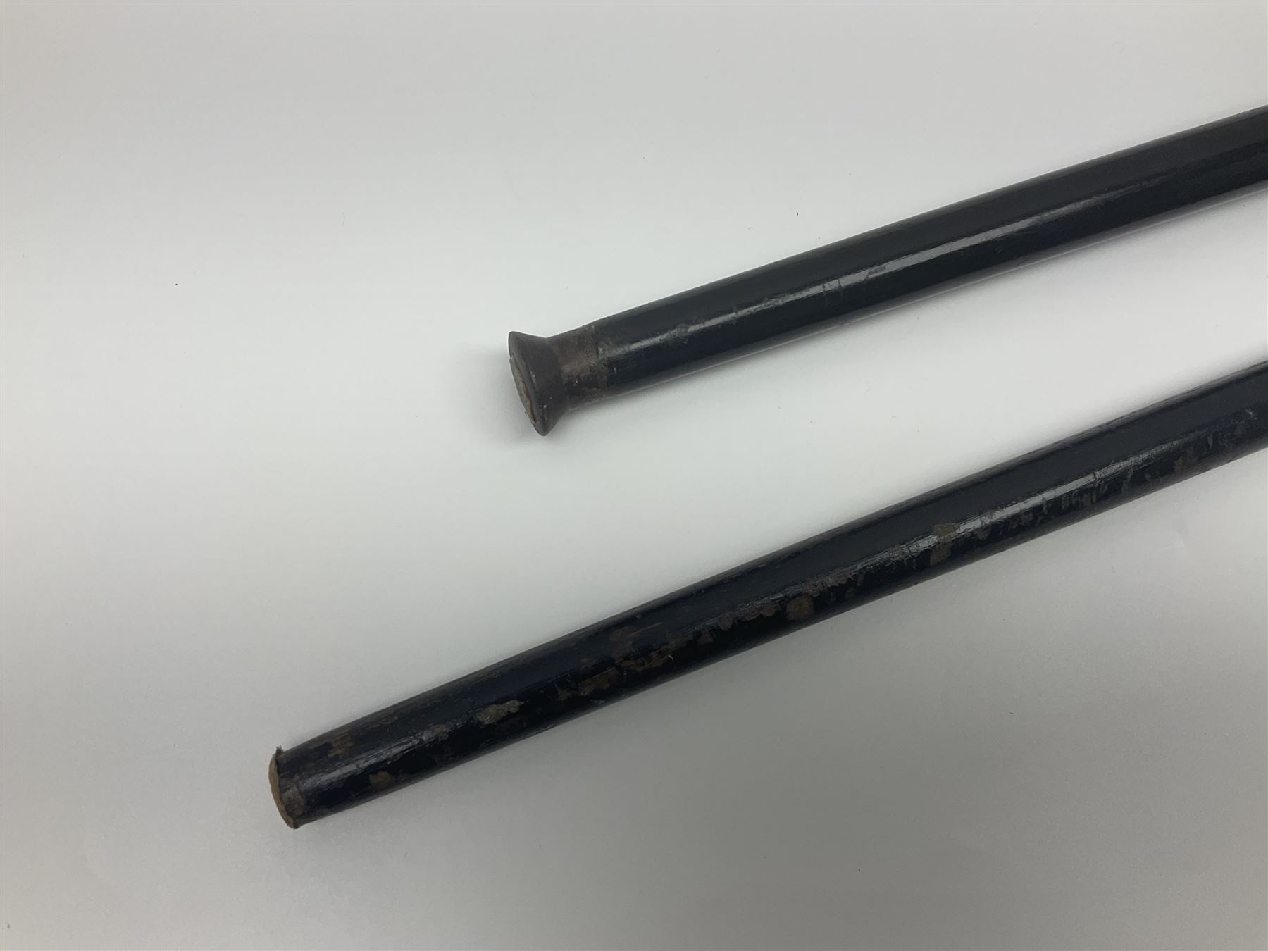 Two ebonised walking sticks, one with 'Leeds City Police' embossed top, tallest H92cm