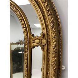 Gilt Rococo style mirror, arched top with central cartouche and oak leaf moulded pediment, floral and fruit moulded surround with segmented glass panels, bevelled central pane, c-scroll shell and acanthus leaf brackets