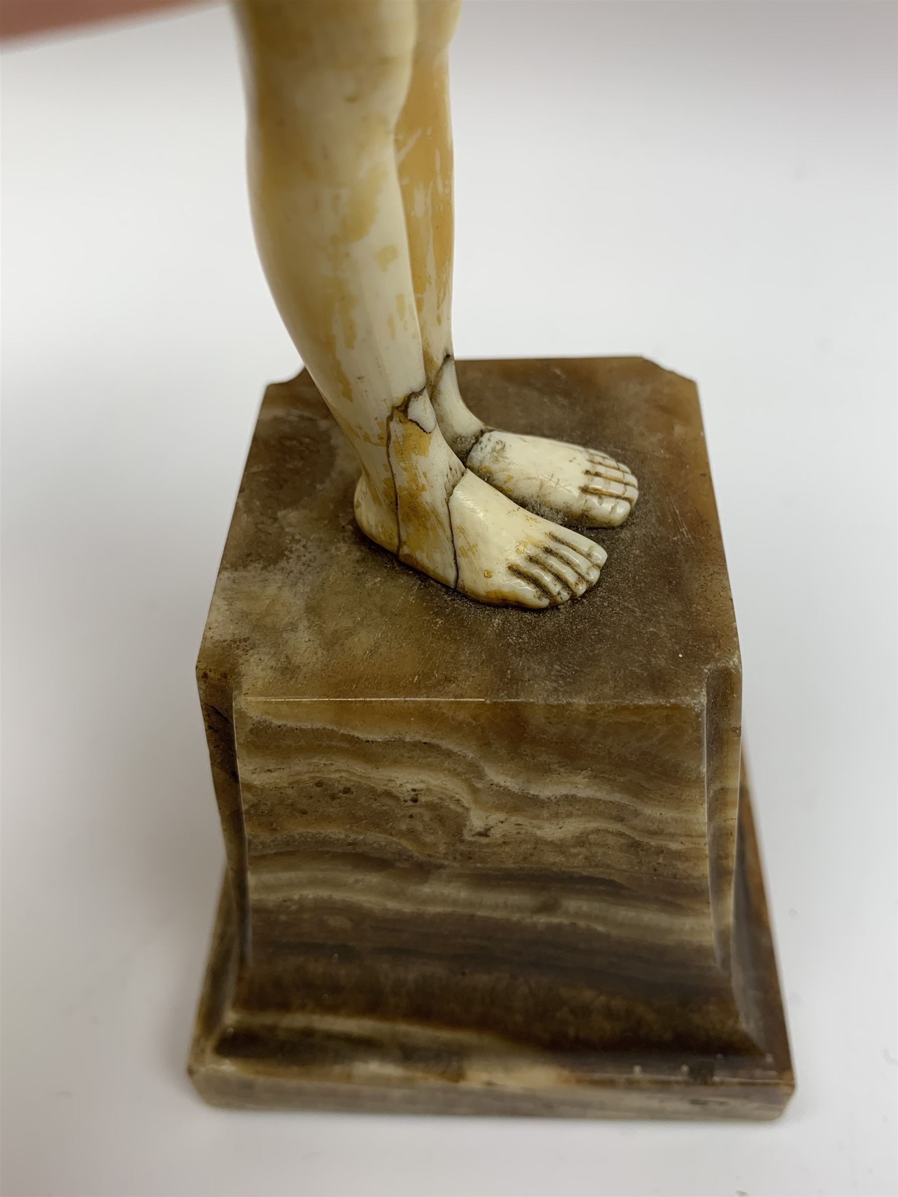 Demetre Chiparus (1886-1947): Innocence, a gilt bronze and ivory figure, circa 1925, standing in contemplative post with hands clasped, upon onyx plinth, signed to base, H24.4cm