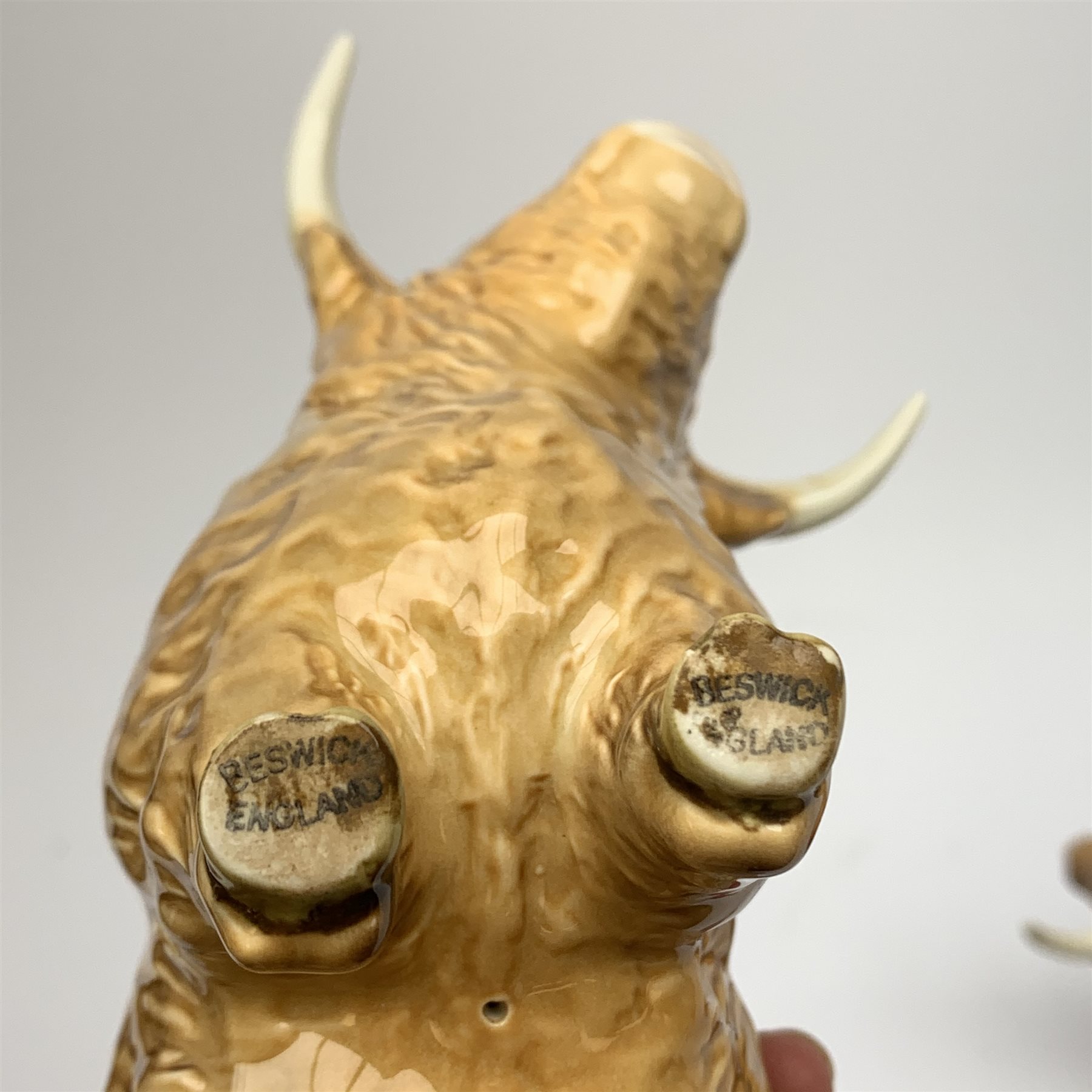 A Beswick Highland Bull, Highland Cow, and Highland Calf, each with printed mark beneath. 