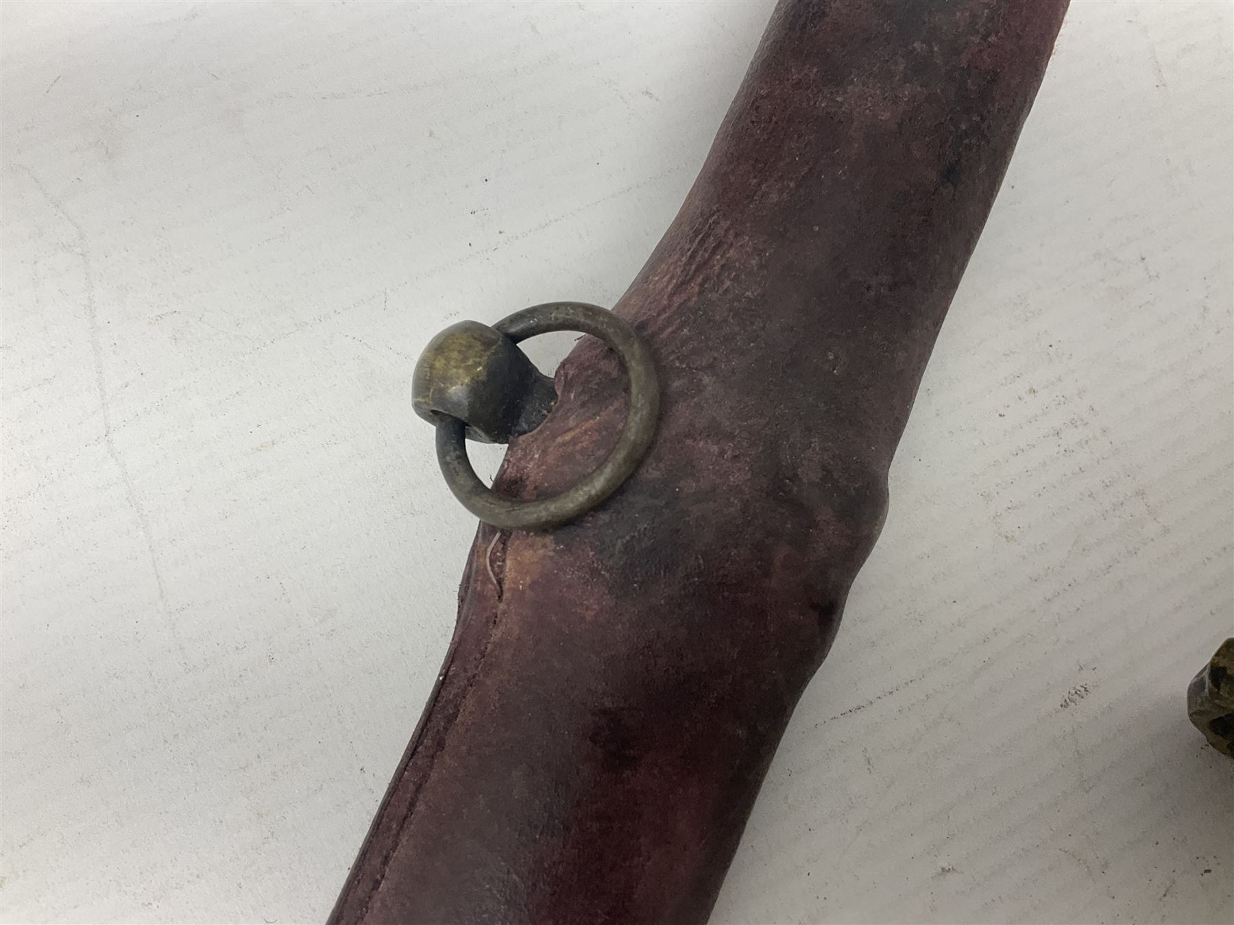 Copy of a WWII Japanese NCO sword, the 65cm slightly curving blade stamped with pseudo Japanese characters and cast brass simulated cord bound grip; in officer's leather bound field scabbard L97cm overall