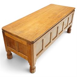 Mouseman - 1950s adzed oak blanket chest of unusual proportions, the rectangular hinged top with canted corners, over a sextuple panelled front, raised on turned octagonal feet, carved with mouse signature, by the workshop of Robert Thompson of Kilburn