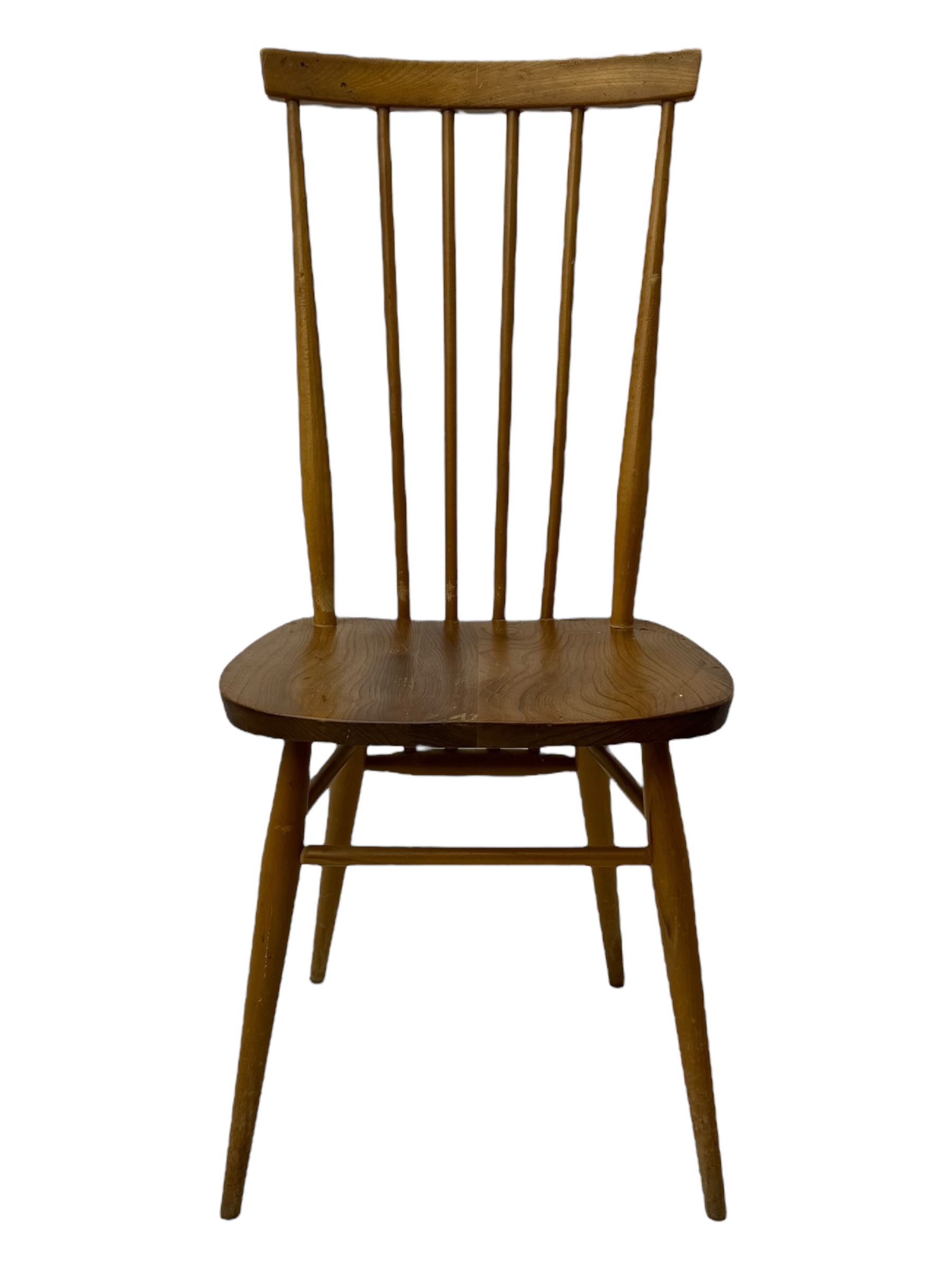 Ercol - pair of mid-20th century highback 'Windsor' chairs, curved top rail over six vertical spindles and shaped seat, on tapering cylindrical supports with stretchers