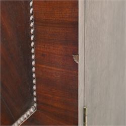 George III mahogany linen press, moulded cornice above a pair of panelled doors with gadrooned beading above a gadrooned edge over two short and three graduated drawers, with shaped apron, raised on sabre feet  