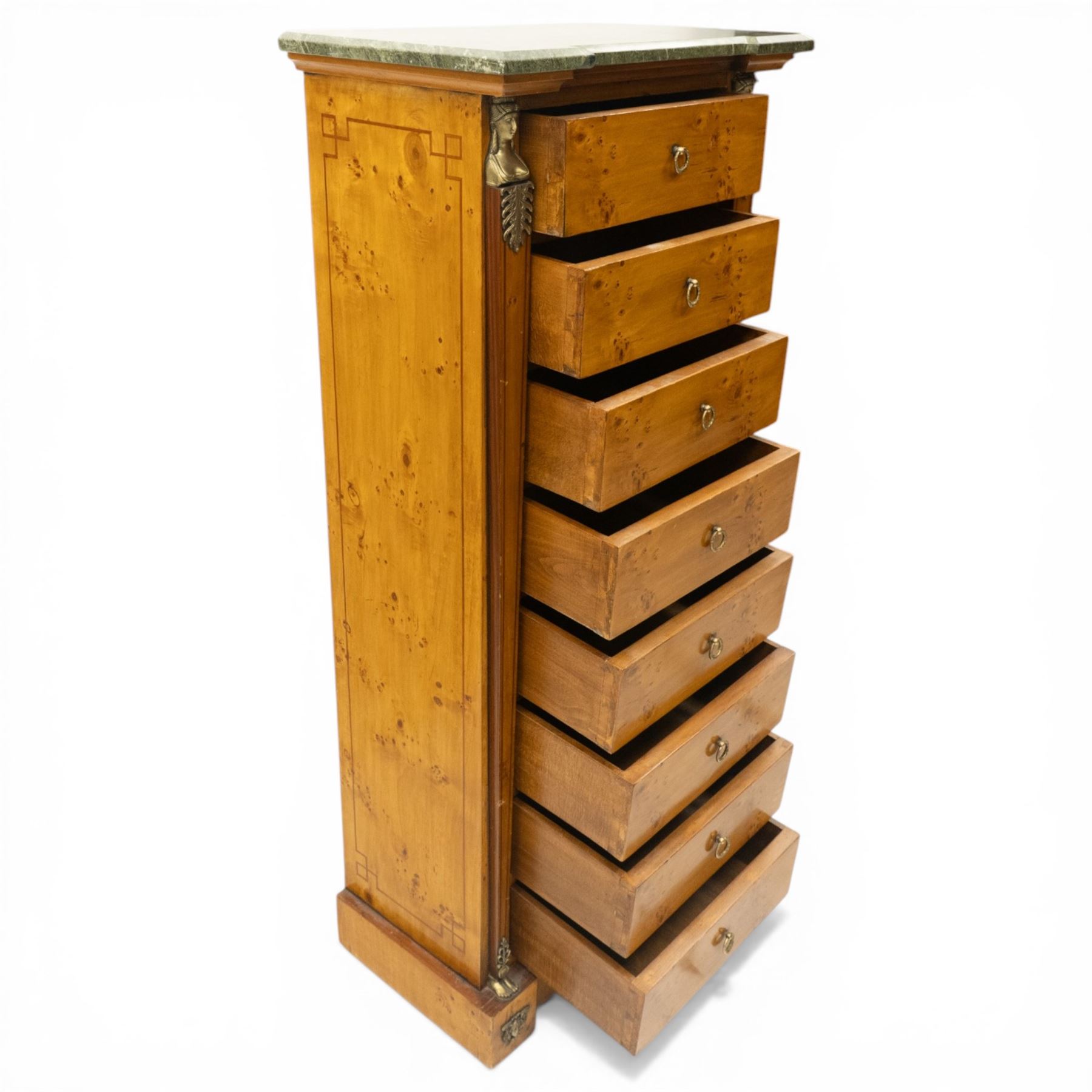 Neoclassical marble and inlaid figured maple wood tall chest, green marble inverted-breakfront top over eight long drawers, flanked by square tapering pilasters with gilt metal female bust and anthemion leaf capitals and brass feet terminals, the skirted base with applied Medusa gilt metal mounts, on compressed bun feet