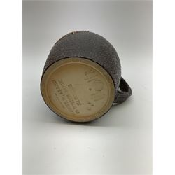 A Doulton Lambeth stoneware jug, with silver mounted collar, hallmarks rubbed, maker's mark probably Cornelius Desormeaux Saunders & James Francis Hollings (Frank) Shepherd, the leather effect body titled 'Drinke Faire Don't Sware', with impressed marks beneath including 'Manufactured for Sidney W Allen 39 White Rock Hastings', H18.5cm. 