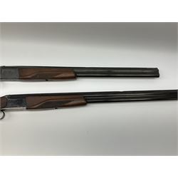 Two Russian Baikal 12-bore over-and-under double barrel boxlock non-ejector sporting guns; one with 68.5cm barrels, walnut stock with chequered pistol grip and fore-end and thumb safety, serial no.520545, L111cm overall; the other with 72.5cm barrels, walnut stock with chequered pistol grip and fore-end and thumb safety, serial no.012448, L114.5cm overall (2) SHOTGUN CERTIFICATE REQUIRED