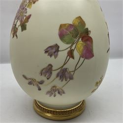 Royal Worcester, blush ivory twin handled vase, the bulbous body decorated with hand painted flowers, the tall tapering neck with foliate pierced detail and gilt finish, with printed mark beneath 