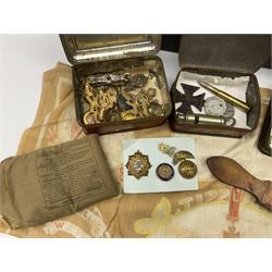 Quantity of cap badges and buttons including Royal Artillery, RASC, Northumberland Fusiliers, Yorkshire Dragoons Y.C. 'button' brooches, Royal Munster Fusiliers buttons etc; WW1 French spurious iron cross, trench art shell case dip pen, military whistle, Army razor strop and other militaria; all in large tin box