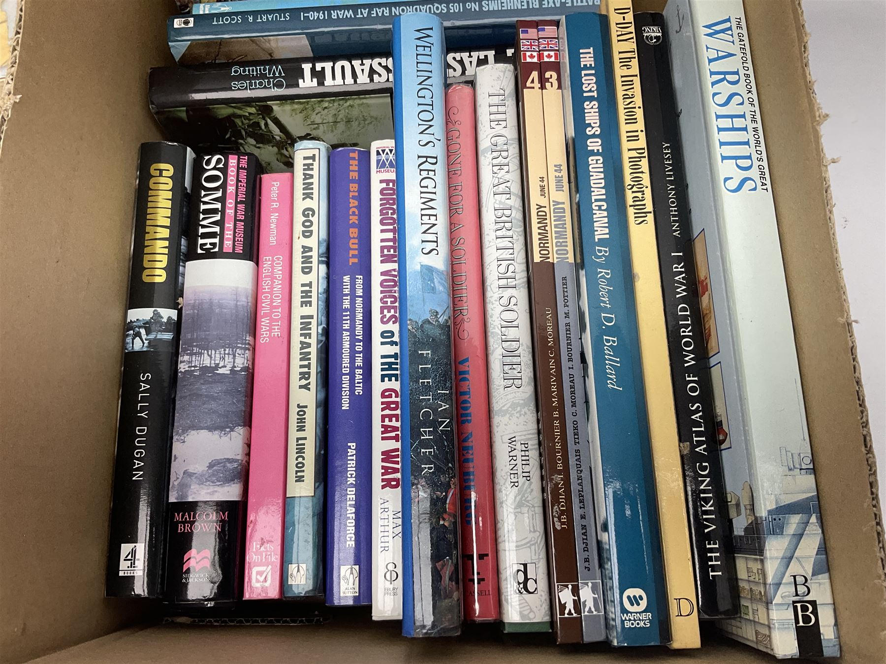 Large collection of hardback and paperback books, mainly military books, to include Band of Brothers, Dawn of D-Day, Dessert Warrior, Book of the Somme, Battle of Britain, etc in four boxes  