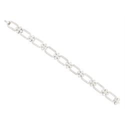 18ct white gold and platinum, milgrain set old cut diamond flower head and openwork panel link bracelet, total diamond weight approx 4.25 carat