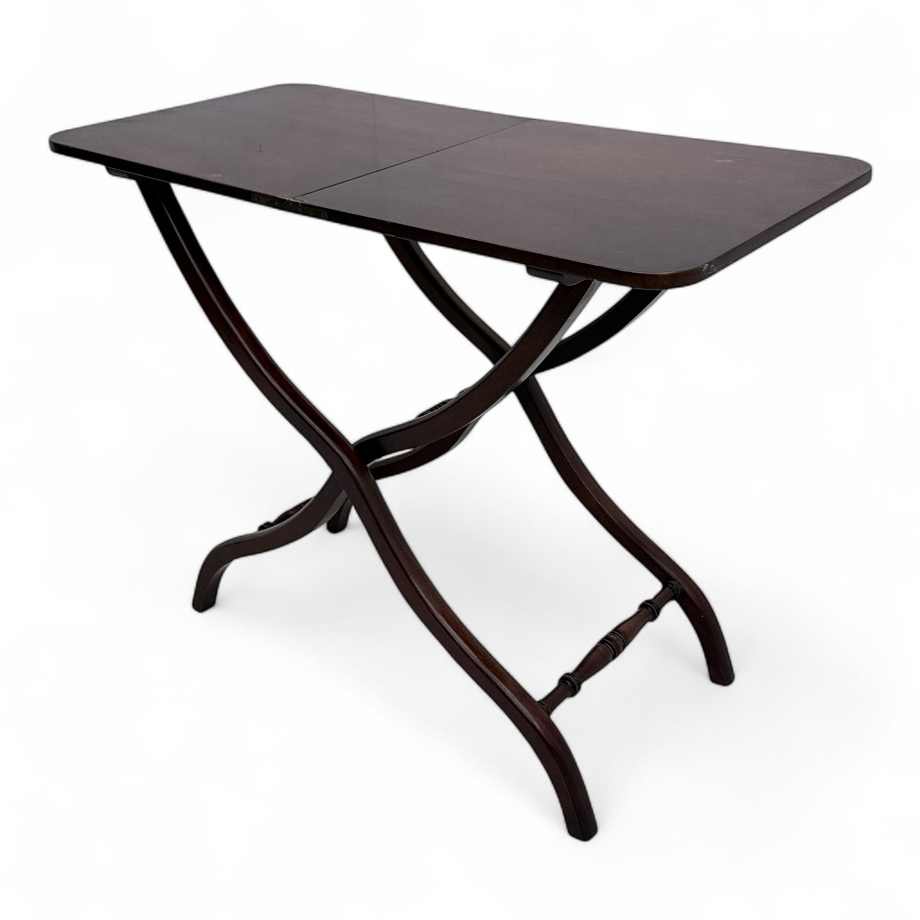20th century mahogany folding coaching table, hinged rectangular  folding top, divided into two sections, supported on an X-frame with turned stretchers 