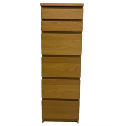 IKEA light oak finish chest, fitted with hinged vanity top, above six graduating drawers 