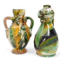 Two early 20th century Italian glazed terracotta wine flasks, one of twin handled form, applied with shells and insects, the other formed as a male figure, H24cm (2)