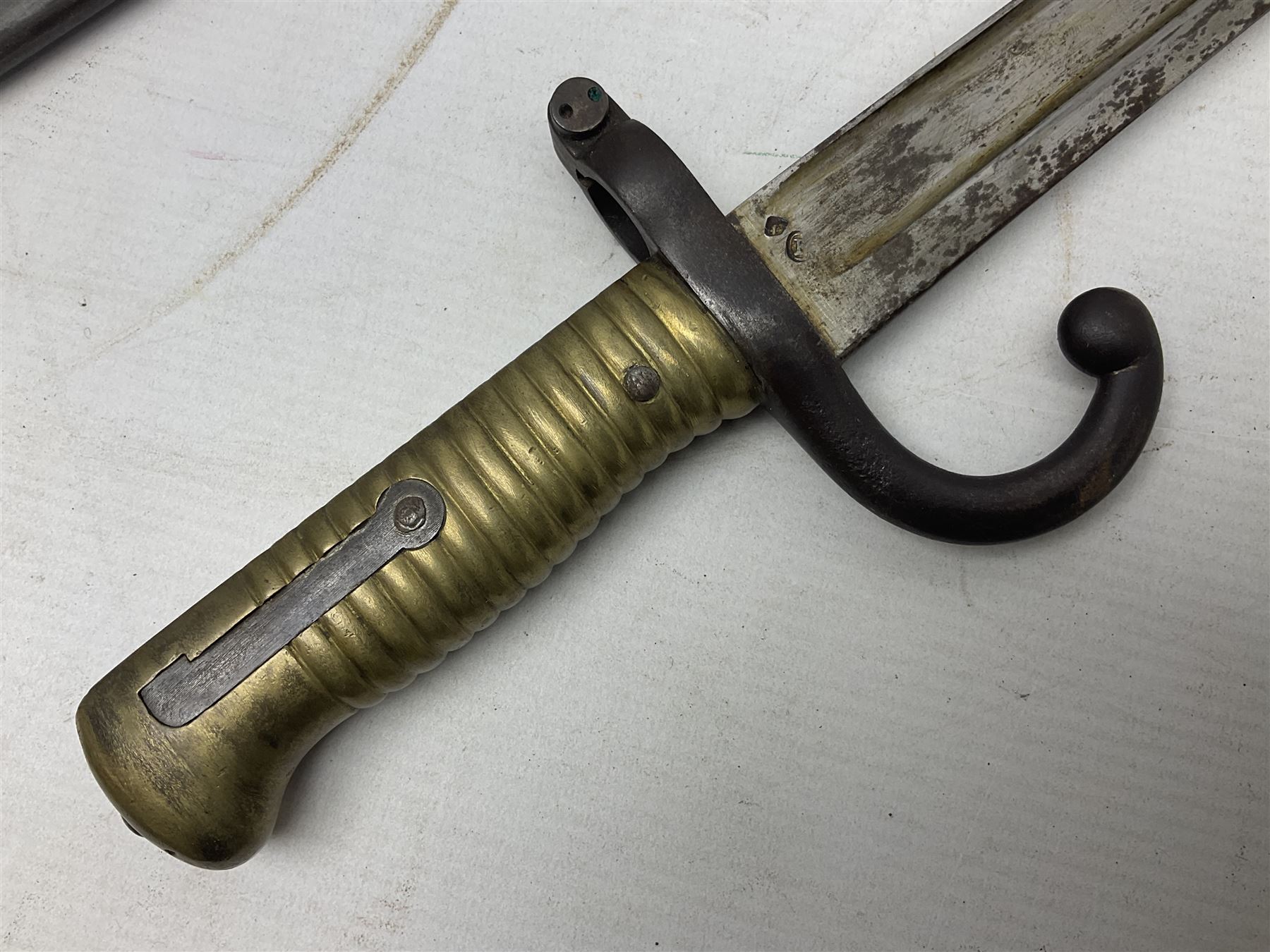 French Model 1866 Chassepot bayonet with 57cm curving fullered steel blade dated 1873 No.L63963; in steel scabbard with conforming number L71.5cm overall; and French St. Etienne Gras bayonet dated 1878 No.K10674 in steel scabbard numbered 79437 (2)