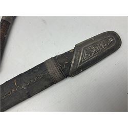 Omani presentation sword kattara, with 77cm  broad slightly curved single edge blade with two fullers, leather bound hilt woven with silver wire decoration and iron pommel;  in tooled leather scabbard with chased silver mounts and presentation plaque 'To Capt. D.M. Naylor From C Company NFR Oman Dec 1962' (Northern Frontier Regiment) L99cm overall