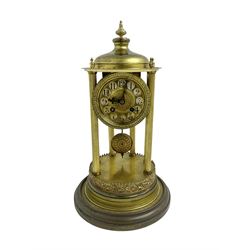 French - early 20th century 8-day portico clock under a glass dome, on a shaped circular brass base with a decorative repousse border to the plinth, six reeded columns with finials and an ogee top with matching finial, gilt dial with cartouche Arabic numerals and pierced hands, countwheel striking movement, striking the hours and half hours on a bell. With pendulum and key. 