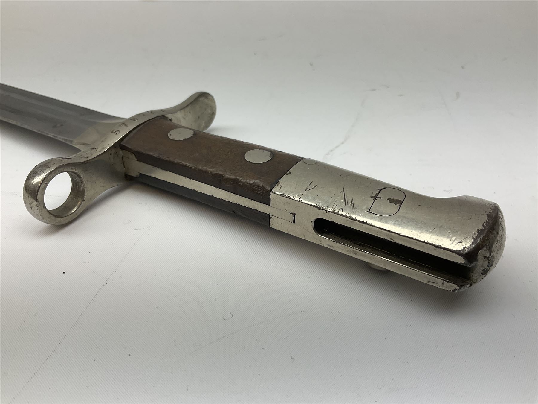 British Enfield 1907 model SMLE bayonet, with 43cm fullered steel blade and metal mounted leather scabbard L58cm overall; and Schmidt-Rubin Model 1918 bayonet the 30cm steel blade marked Elsener Schwyz No.579722; in steel scabbard with leather frog marked G. Bertolini Sellaio Vira/G.Tic 79 L45cm overall (2)