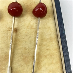 A cased set of six Art Deco Sterling silver cocktail sticks with cherry modelled terminals, marked Sterling silver. 
