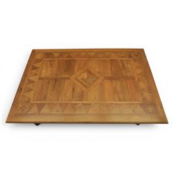 20th century Spanish design oak coffee table, rectangular parquetry top with geometric star and triangular inlaid decoration, moulded edge, on shaped trestle end supports united by black painted wrought iron scroll stretchers