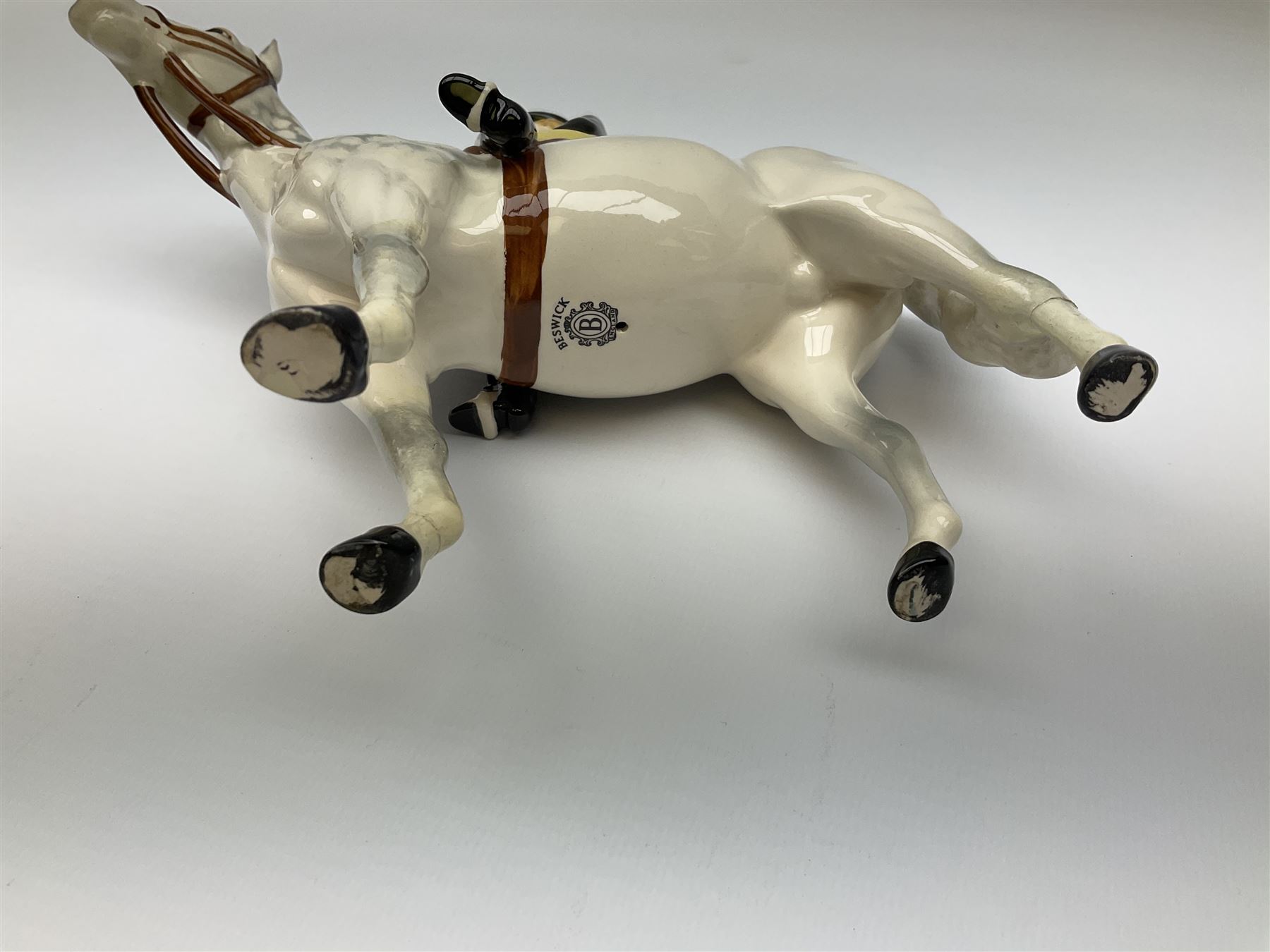 Beswick model of a huntswoman on grey horse model no 1730, and Beswick huntsman on brown horse model no 1501, both with printed mark beneath. 