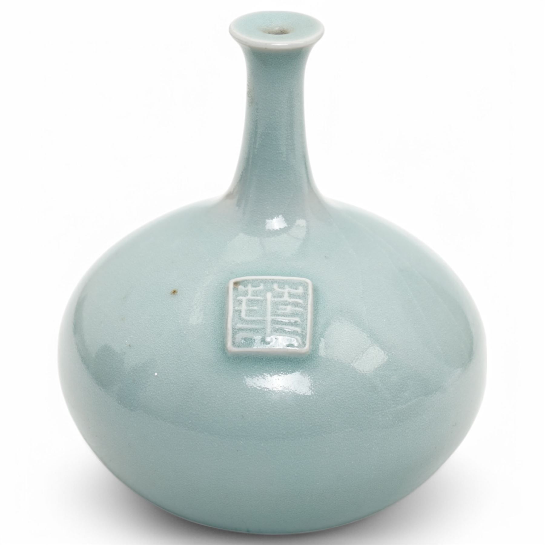 Poh Chap Yeap (Chinese/British 1927-2007); celadon glazed plate and solifleur vase, the plate decorated with a branch of cherry blossom, incised signature to bases, plate D29cm, vase H11cm (2)