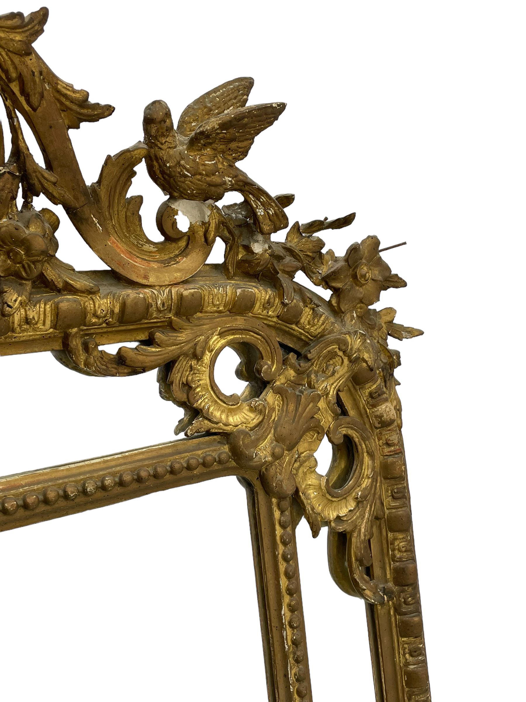 19th century giltwood and gesso pier mirror, shell cartouche pediment decorated with flower heads and scrolling foliage, two bird motifs to each side, egg and dart moulded frame with beaded inner slip, plain mirror plate, each corner mounted by scrolled acanthus leaves and cartouches