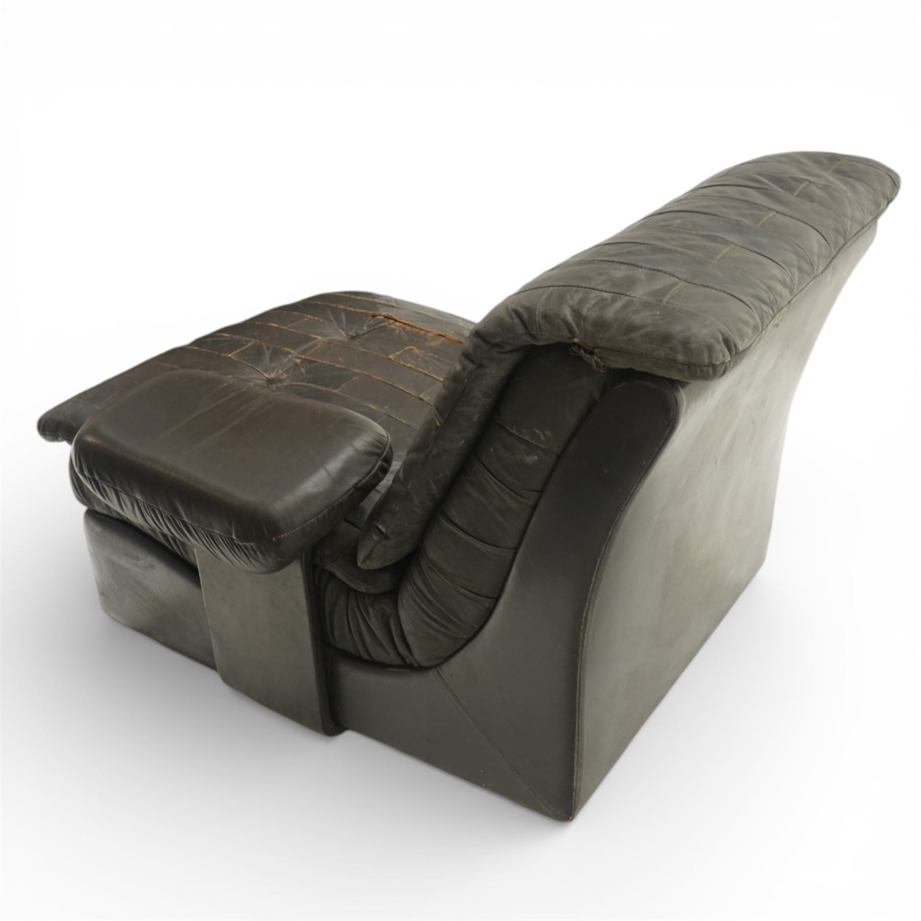 Mid 20th century leather upholstered two-piece sectional sofa with footstool, buttoned back cushions with stitched panel decoration, padded armrests and deep seat cushions, raised on concealed supports