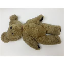 1950s sheepskin plush covered teddy bear with musical movement, the revolving head with applied eyes, leather nose and stitched mouth, jointed limbs with leather pads H50cm