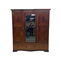 Edwardian inlaid mahogany triple wardrobe, fitted with centre bevelled mirror enclosed by two segmented veneered doors
