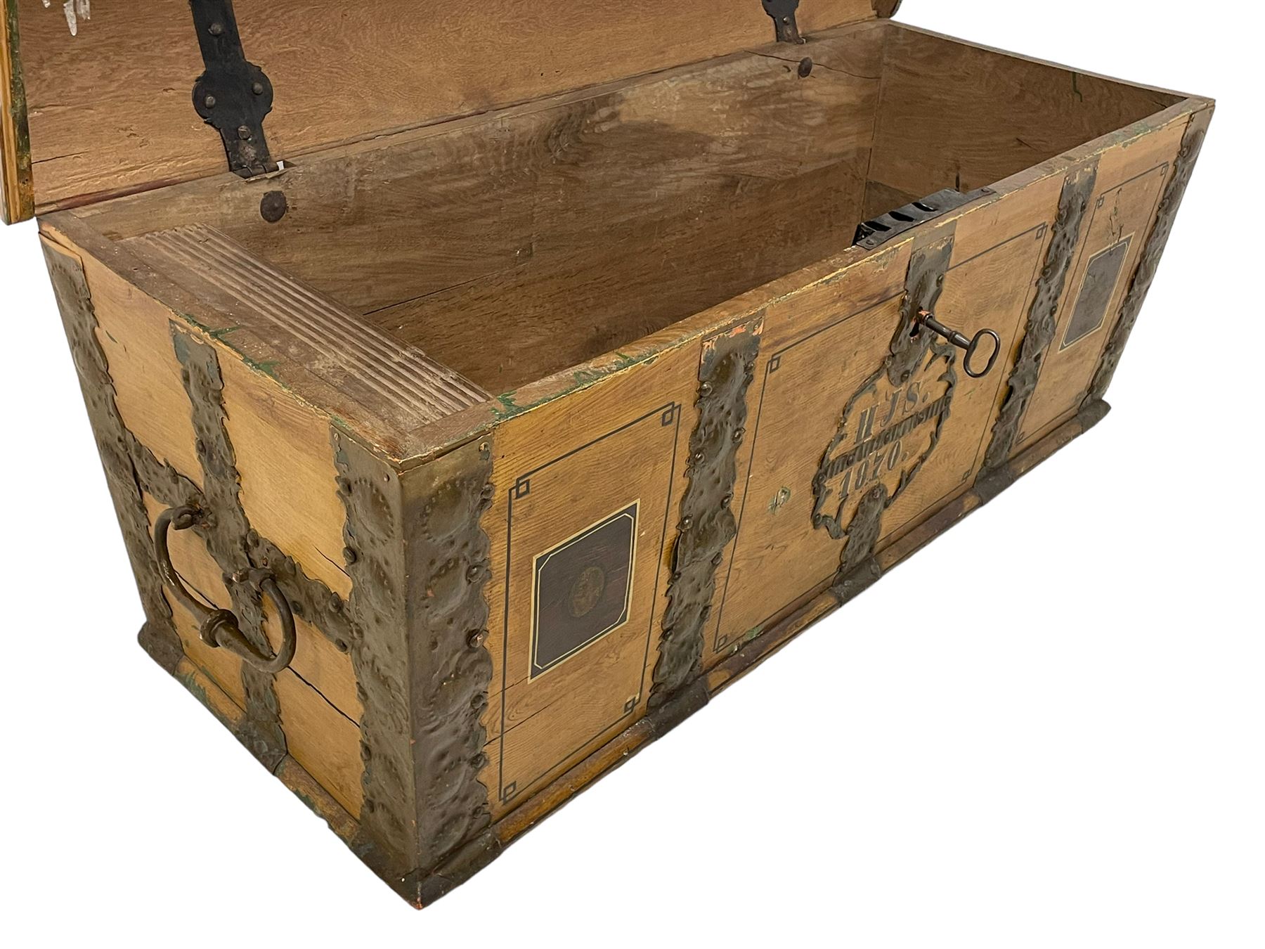 19th century painted oak sea chest, hinged dome top enclosing small compartment, bound by shaped and pressed metal strapwork, scumbled finish to resemble oak and painted with small vignettes depicting portraits and landscapes within panels, fitted with large wrought metal carrying handles, the front inscribed 'H.J.S. 1870' 