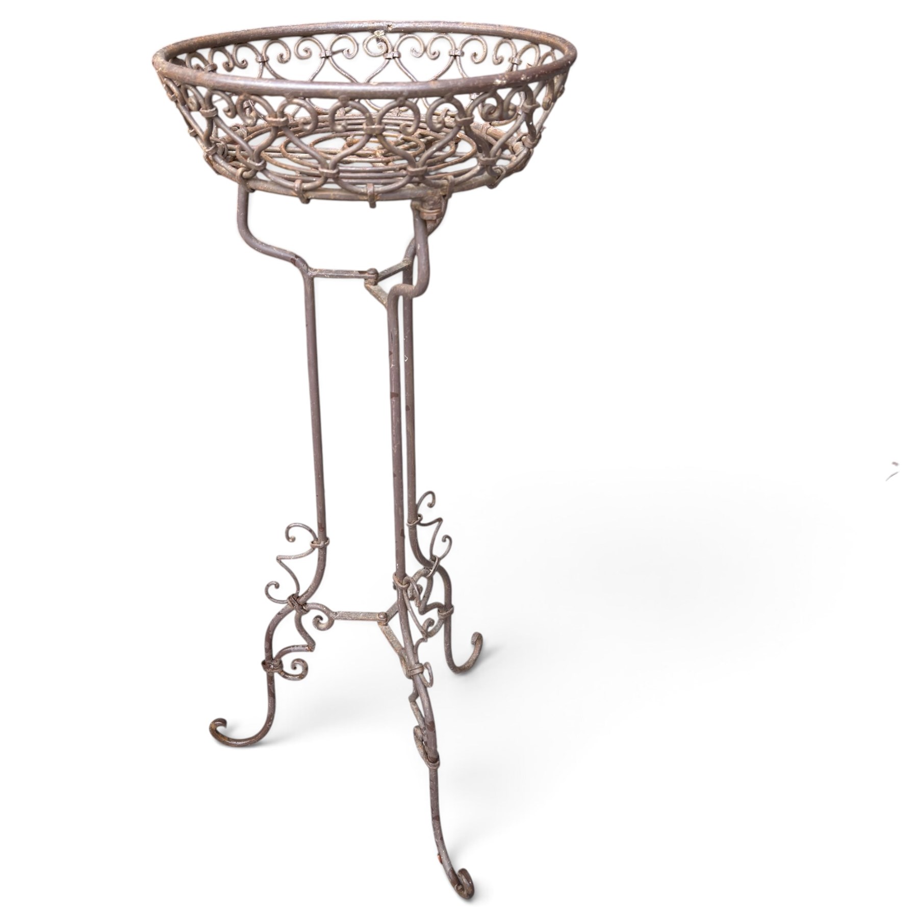 Three wrought iron garden basket planters, comprising a circular pierced and scrolling basket on tall tripod stand with scrolling supports (W31cm H76cm), and a pair of matching hanging baskets (W37cm H30cm)