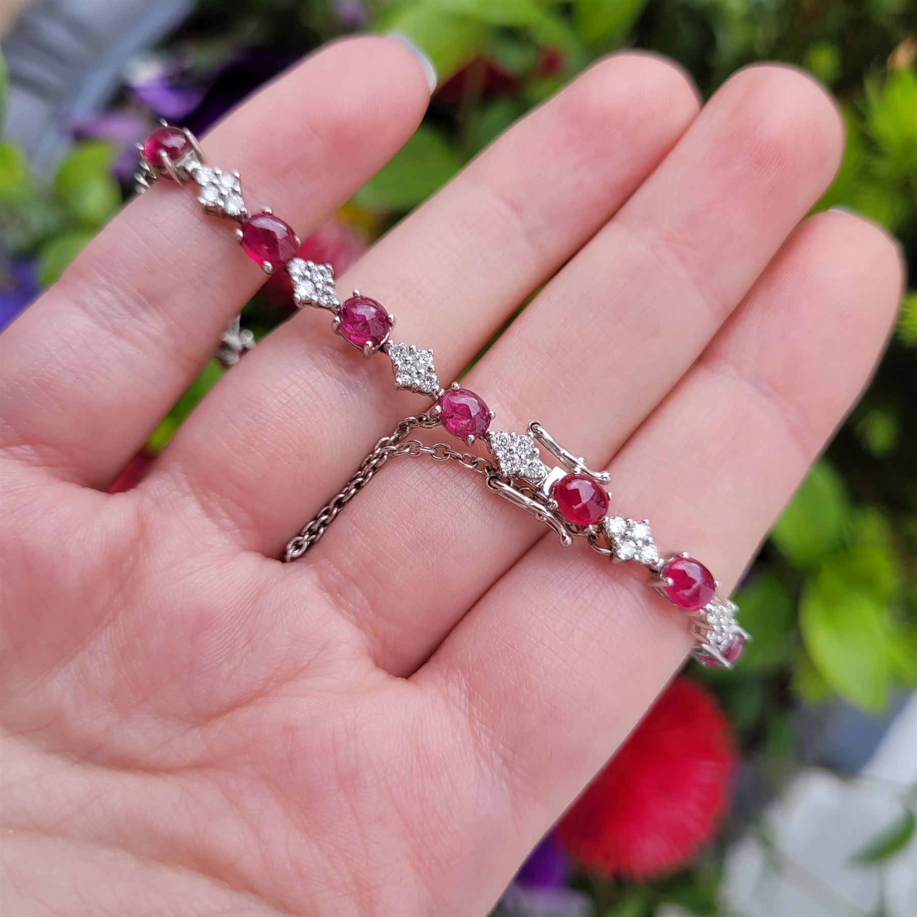 18ct white gold ruby and diamond bracelet, fifteen oval cabochon cut rubies, each spaced by four round brilliant cut diamonds, Sheffield 2009, total ruby weight 10.10 carat, total diamond weight approx 0.60 carat