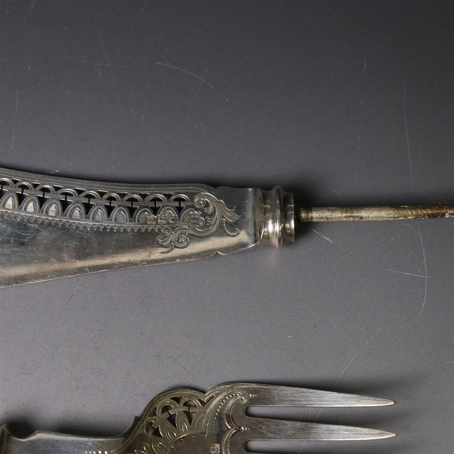 Pair of late Victorian silver fish servers, each with pierced and engraved geometric decoration, hallmarked Goldsmiths & Silversmiths Co, London 1896, handles removed, contained within fitted case