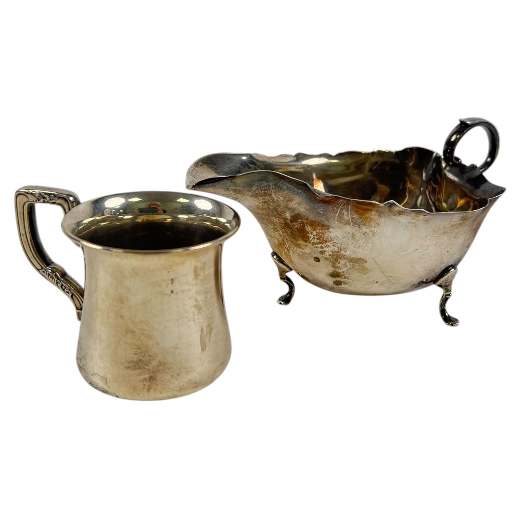 Silver sauce boat, hallmarked and a small silver christening mug, stamped sterling