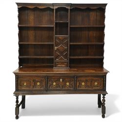 19th century Jacobean Revival oak dresser and rack, the upper section with open shelves an...