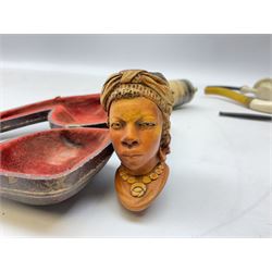 Carved meerschaum and amber pipe with silver mount, the bowl carved as a woman, cased, clay pipe in the form of an acorn, ceramic pipe, five other pipes and a ceramic bottle pourer in the form of a horse  