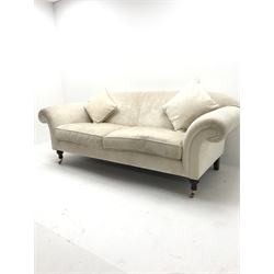 Three seat sofa upholstered in an cream chenille fabric, scrolled arms, turned supports, W220cm