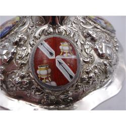 German silver chalice, the bowl, stem and foot each with 19th century repousse and chased decoration depicting putti masks, C scrolls and flowers, set with two hand painted porcelain roundels, possibly Berlin, and six later applied enamel roundels, each depicting religious scenes, the gilded bowl upon knopped stem and spreading octofoil foot, the base with marks for Munich, c.1695 and maker's mark FK