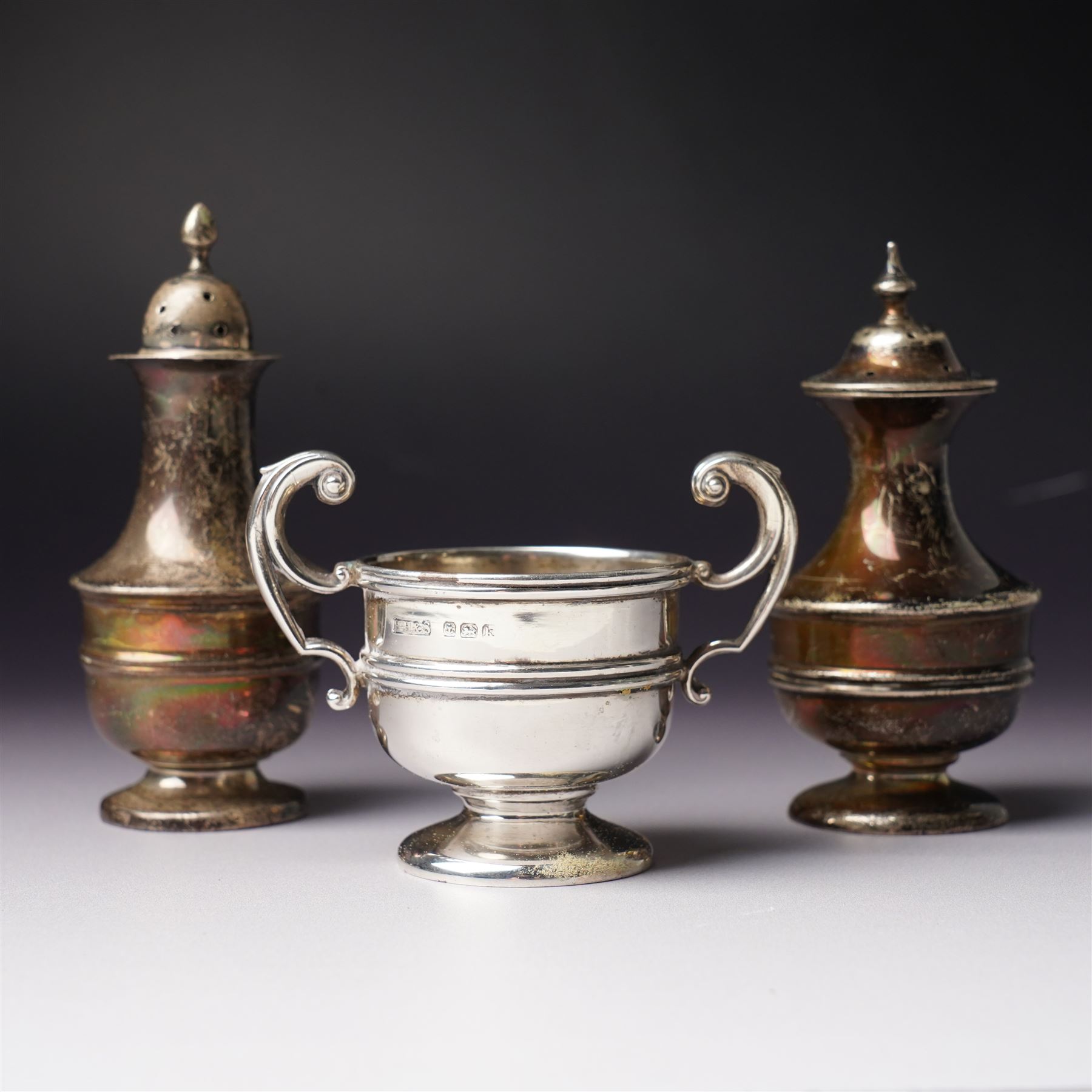 Victorian silver sauce boat engraved with a monogram Sheffield 1892 Maker John Round  & Son Ltd, another with crimped rim Birmingham 1912 Maker Elkington & Co, two silver pepperettes and a small silver challenge cup