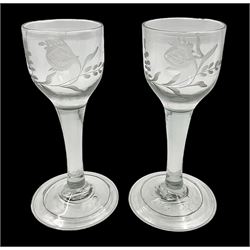 Pair of 18th century Jacobite style wine glasses, the ogee shaped bowls engraved with a single rose and sprig, plain stems upon conical folded feet H13cm