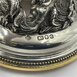 Modern limited edition silver mounted nautilus shell cup, no. 42/150, the pearlescent shell cup with silver-gilt strapwork to rim, upon a stem modelled as a putto supporting a gilt cornucopia and circular domed foot depicting Poseidon amongst swirling waves, hallmarked by St James House Company, London 1980,  H17.5cm